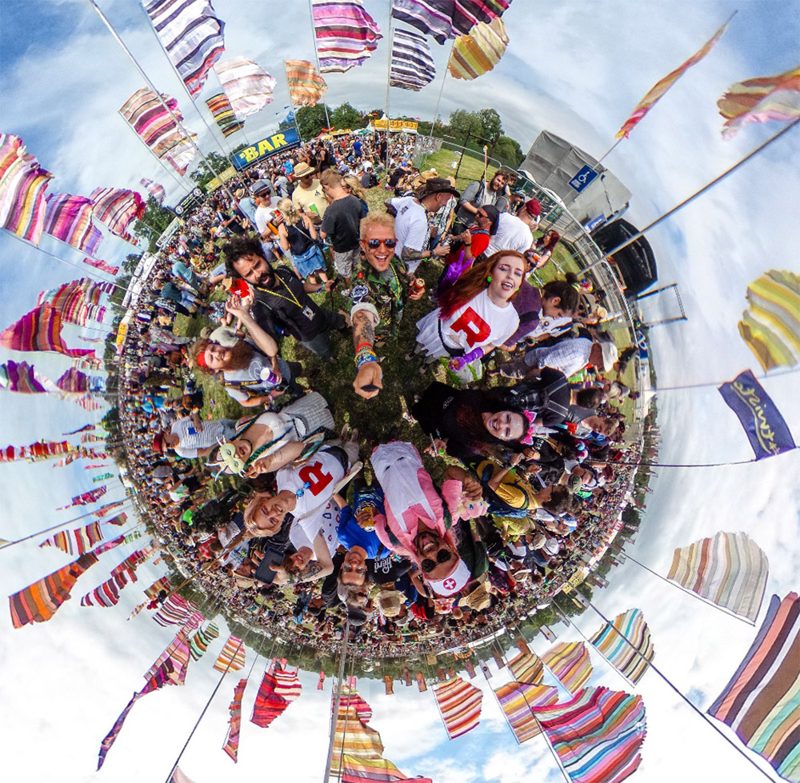 Friends gathered at Glastonbury in a panoramic festival photograph