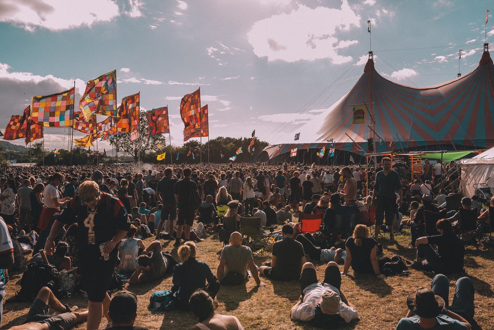 Flags and crowd by the big top, daytime