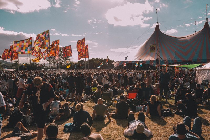 Flags and crowd by the big top, daytime
